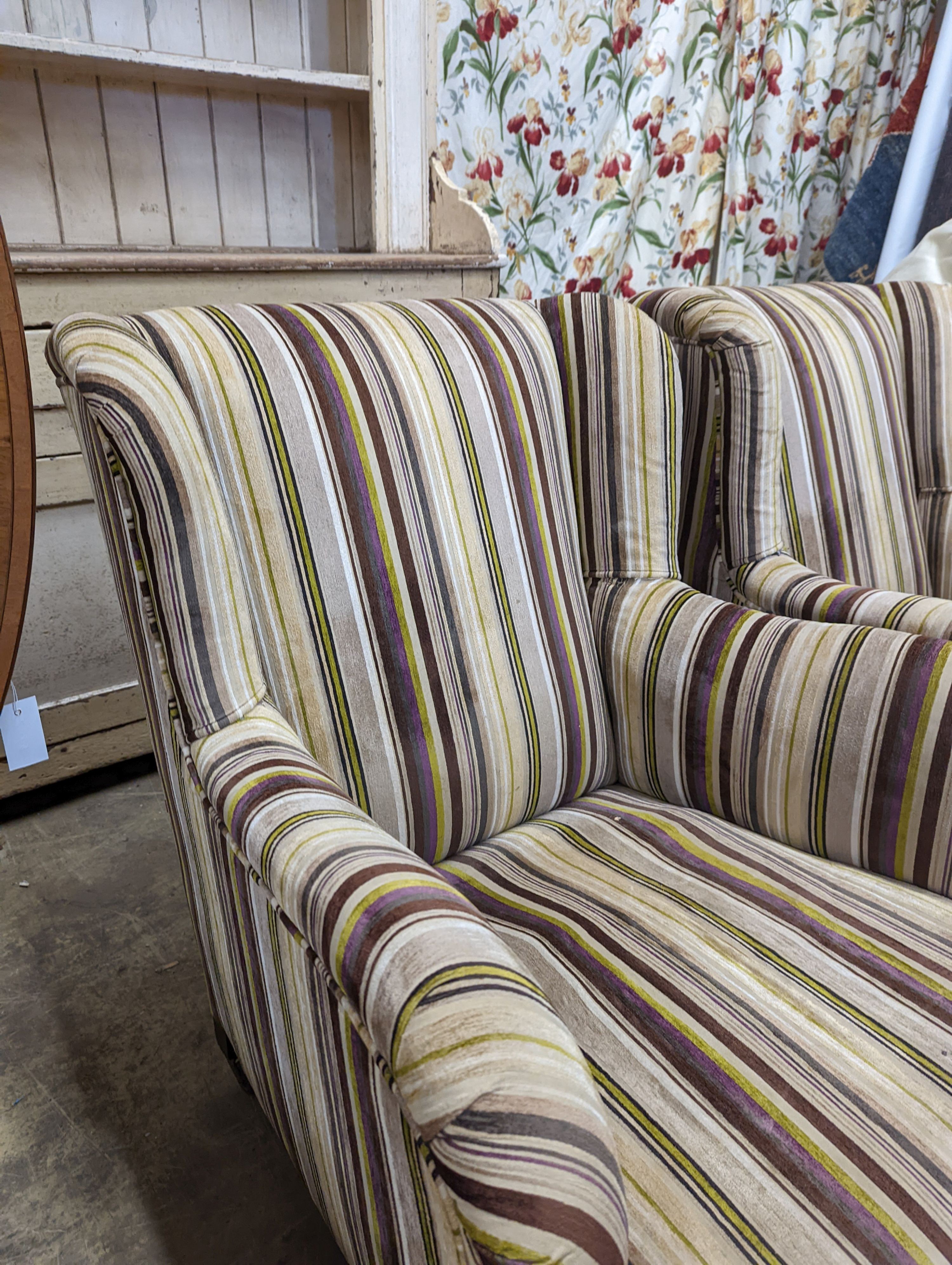 A pair of late Victorian Howard & Sons style armchairs, recently re-upholstered in a contemporary striped fabric, width 76cm, depth 88cm, height 87cm